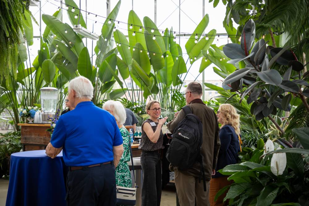 Janel Pettes Guikema chatting with group of colleagues